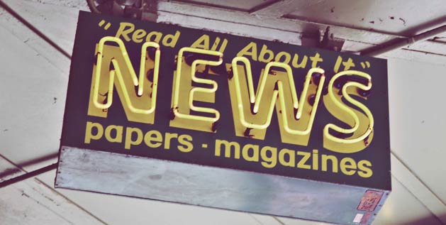 A sign hangs from the ceiling. News, papers, magazines, read all about it