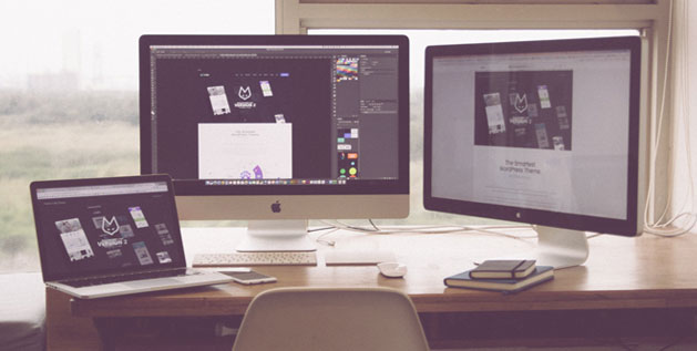 A Photo of a Desk with two computer screens and a laptop showing a website with github logo